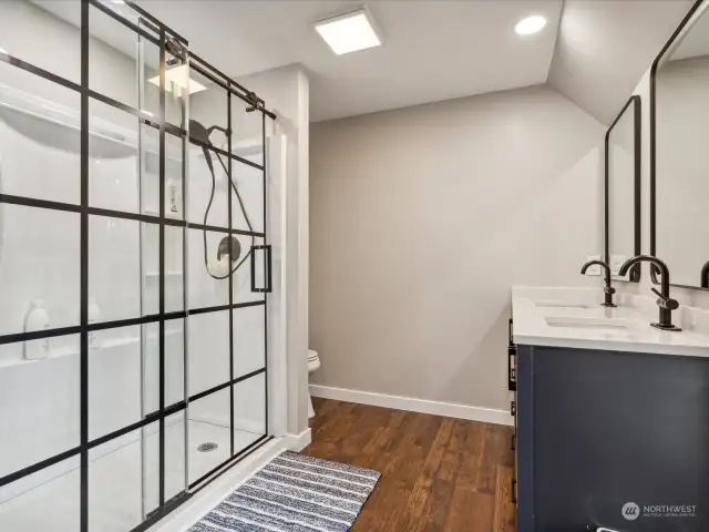 New shower with sliding glass doors.