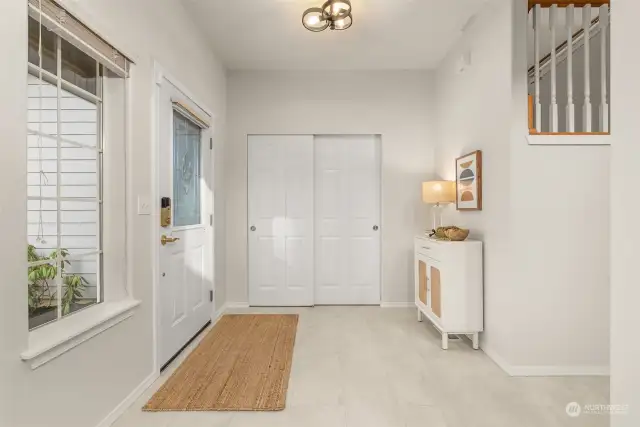 Entryway with updated lighting, flooring and fresh paint.