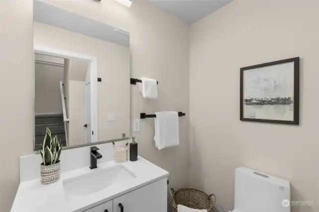 This chic and practical bathroom has matte black fixtures, open shelving, and modern lighting. It's the space that makes getting ready for the day feel like a mini spa moment.