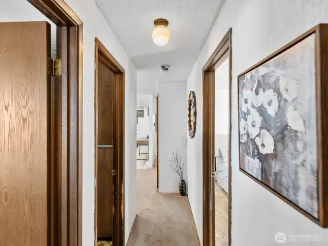 Hallway facing to dining main bedroom and bath to left