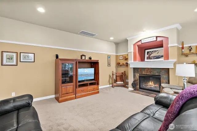 Cozy family room with gas fireplace and brand new carpet.