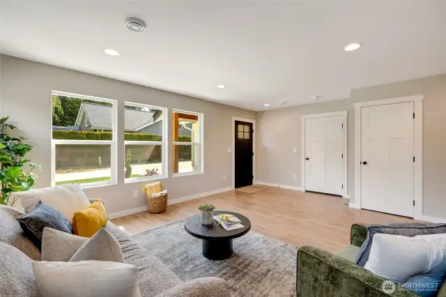 The living room offers convenient access to the front door, garage, and a handy linen closet for extra storage.
