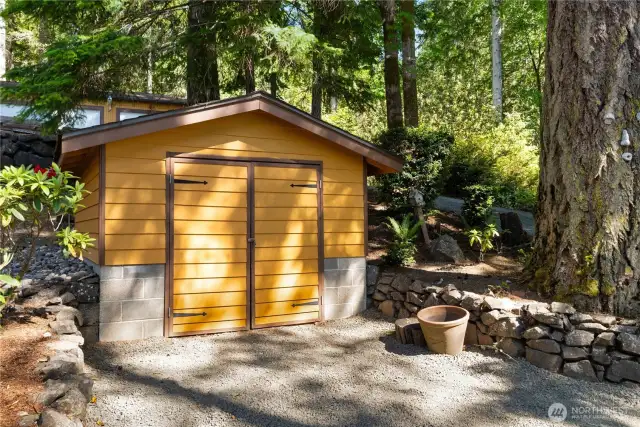 Garden or equipment shed perfect for storing your tractor and potting your planters!