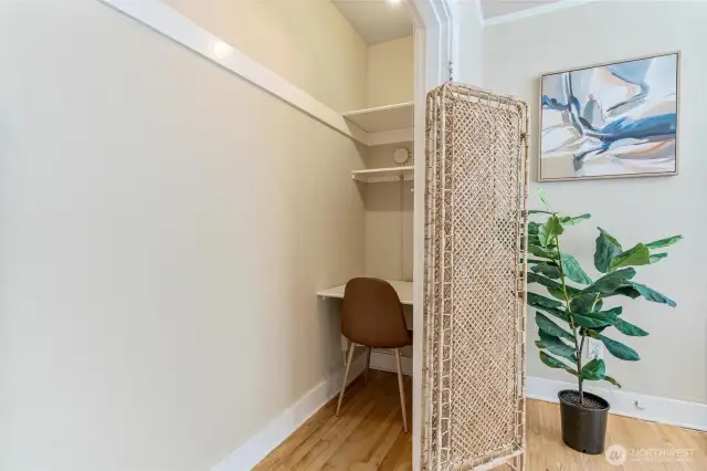 Cozy office corner with classic hardwood floors and tall windows for an inspiring workspace.