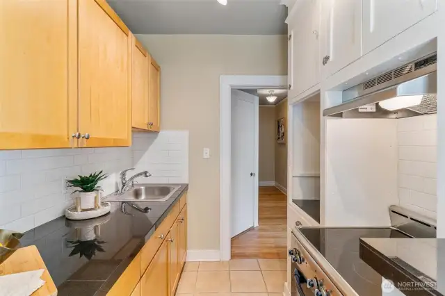 Kitchen with charming vintage style, abundant light, and space-saving design for easy city living.