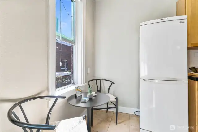 Bright kitchen with charming eating nook, vintage touches, and modern updates for everyday functionality.