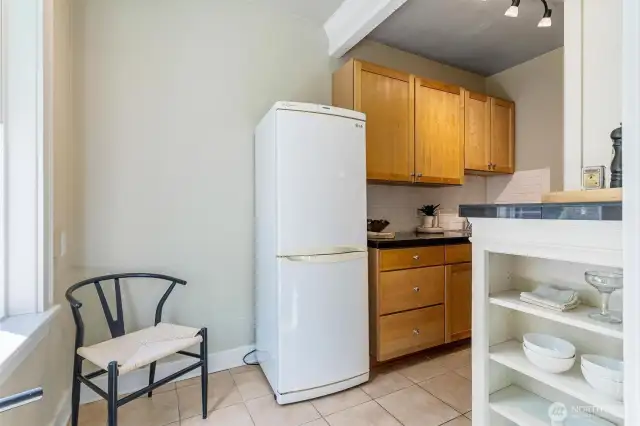 Updated kitchen with historic 1920s character, freshly painted cabinets, and room for a breakfast table.