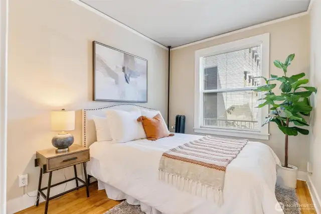Cozy bedroom with oversized windows that flood the space with natural light.