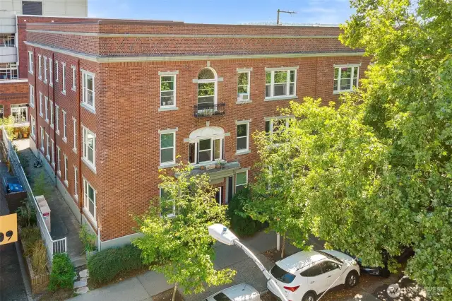 Charming brick exterior with garden surroundings, just steps from UW, cafés, and Light Rail.