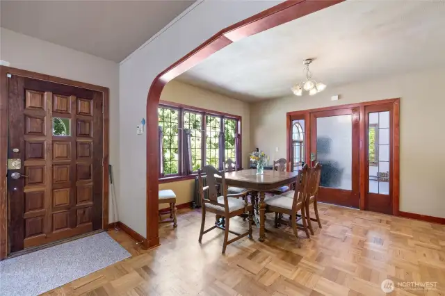 Gothic arches with amazing trimwork lead through the formal dining room.