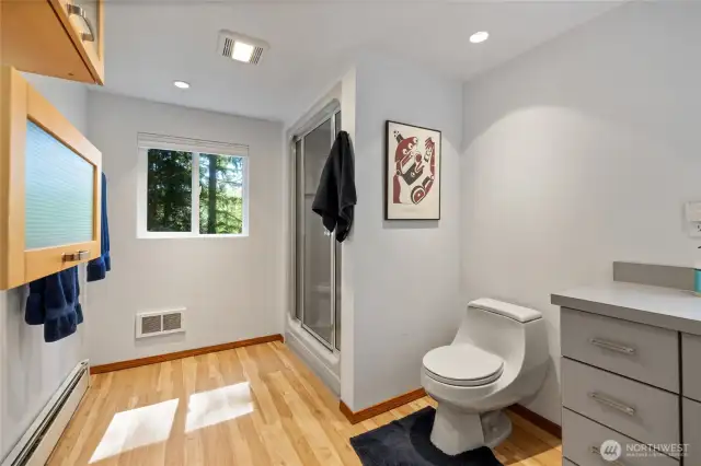 A spacious room with large shower and gleaming hickory floors!