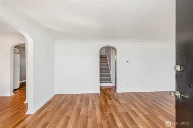 Home enters into the living room with tons of natural light and charming archways.