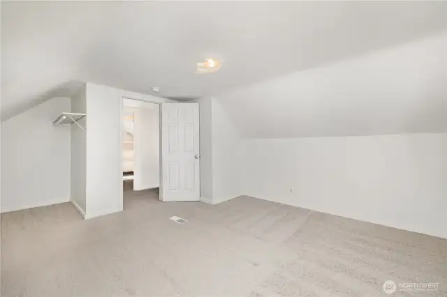 Alternate view of the upstairs bedroom showcasing charming architectural details.