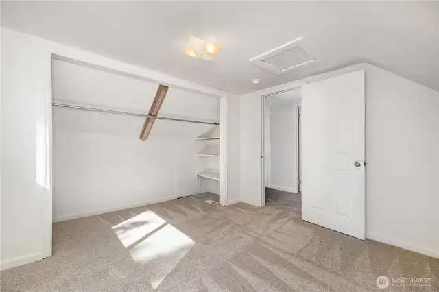 Another view of the second upstairs bedroom featuring generous closet storage.