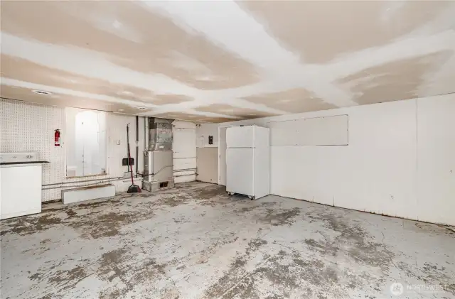 Converted garage space offers abundant overhead storage, while providing excellent workshop or hobby space.