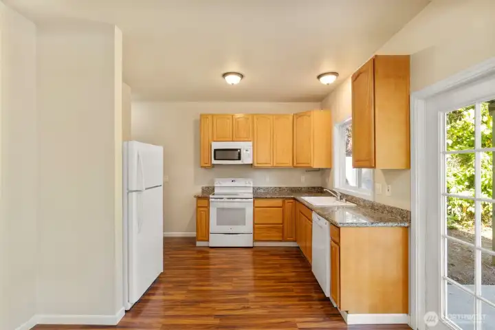 Bright kitchen space with all appliances.