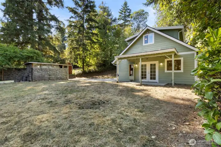 Large yard with shed and garden beds