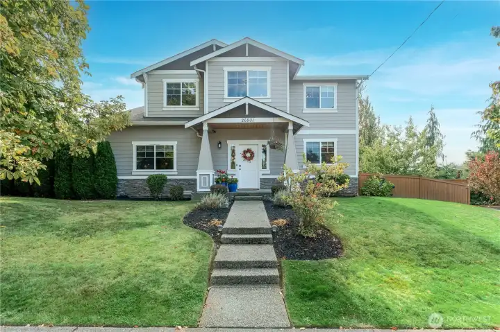 Inviting curb appeal with manicured landscaping, and a clean architectural profile—this home sets the tone for warmth and elegance from the very first glance
