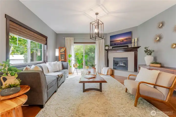 Another picture of the living room with beautiful hardwoods and gas fireplace