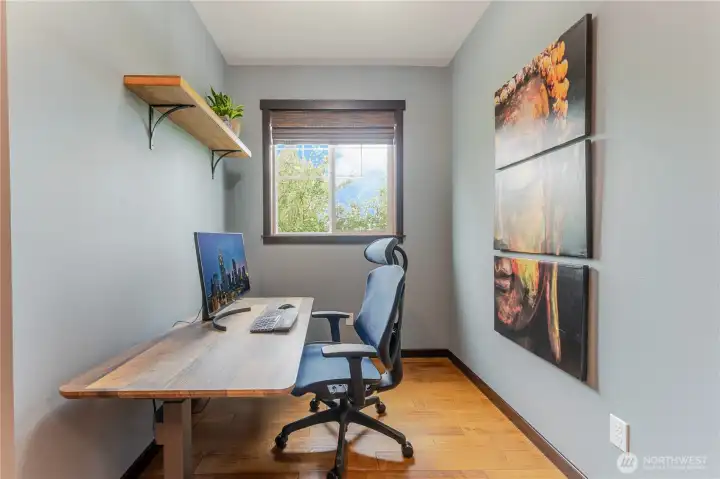Versatile flex space currently styled as a home office—offering natural light and hardwood floors