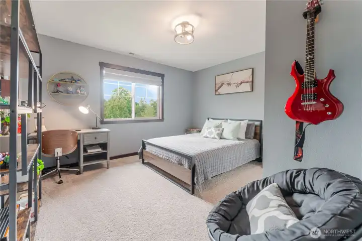 Bedroom #1 features generous natural light, soft neutral tones, and a spacious closet