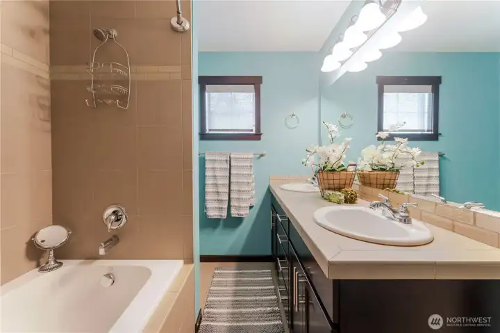 Spacious primary bath with double-sink vanity, soaking tub, and thoughtful tile accents, designed for comfort, function, and a touch of spa-like serenity