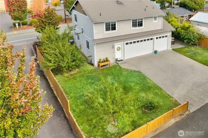 Elevated view of the back of the home showcases its generous lot, private alley access and lush landscaping