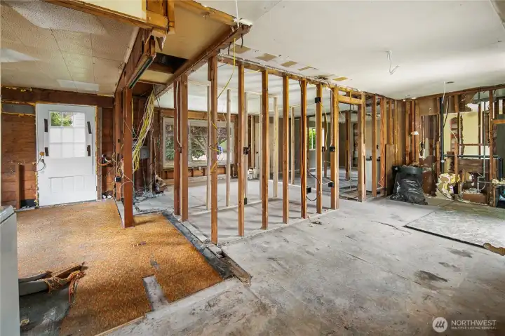 Primary bedroom to the left, hallway, living room, and kitchen.