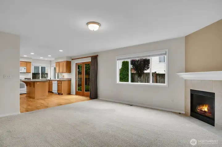 Corner fireplace and large window overlooking the backyard make this family room cozy & bright!
