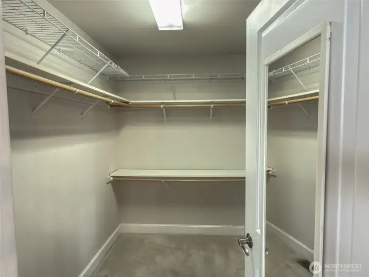 Primary walk-in closet, with lots of storage space.
