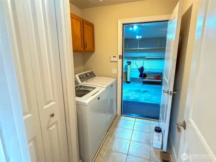 Laundry room is practically located across the hall from the primary bedroom and off the attached garage.