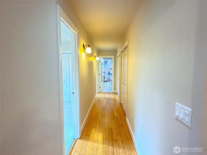 L to R: doorway to the second bedroom, doorway to third bedroom, full bath, and two additional closets.