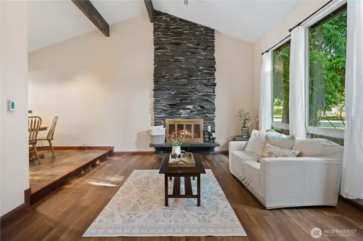 Formal living room has custom stone fireplace.