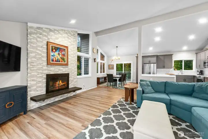 The oversized great room feels bright and airy, with wide-open spaces and windows that stretch to the ceiling, filling the room with natural light.