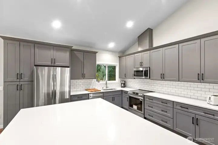 The oversized island takes center stage, providing the perfect gathering spot for entertaining family and friends.