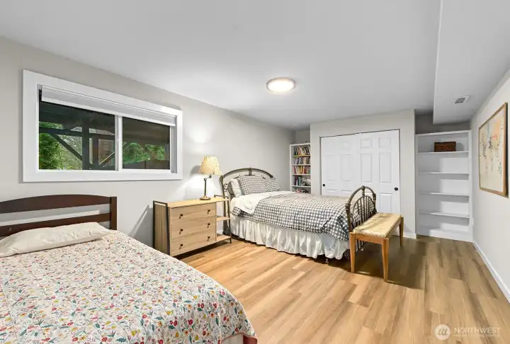 Generous lower-level fourth bedroom with dual closet and large window.