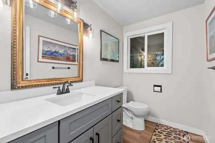 A stylishly updated half bath is conveniently located on the lower level.