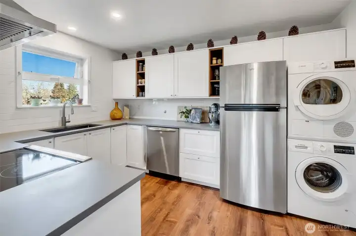 Updated kitchen show cases plenty of counter, prep space- new cabinets and in-unit laundry.