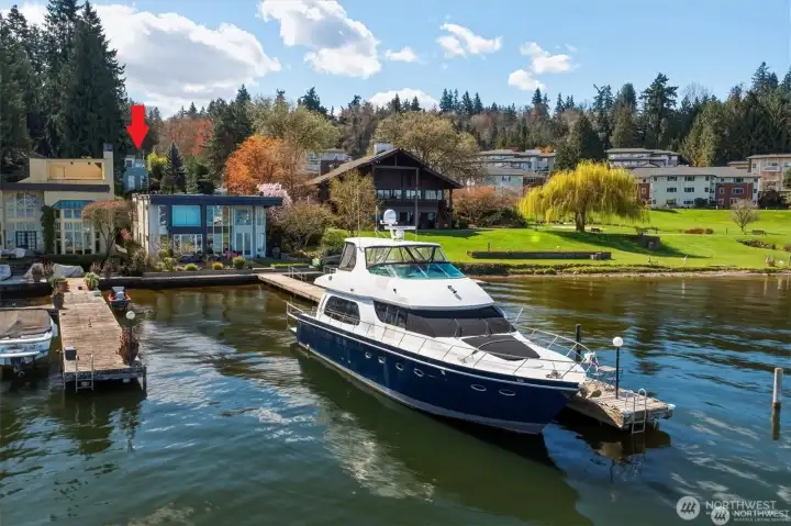 House is the second up from the water and shares 50% of the dock (the entire side with the blue yacht)