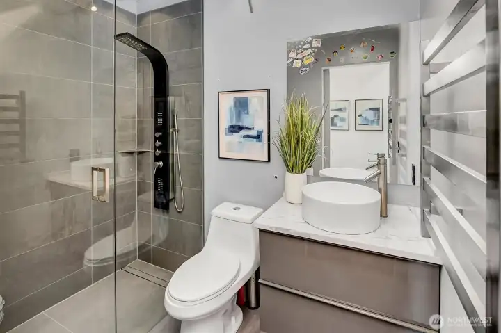 Quartz Vanity and shower with hidden drain and skylight.