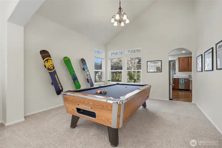 Formal dining room, currently used as a billiards room. Plenty of room, nice fixture and windows. I love the arches in this home as well. Pool table is for sale.
