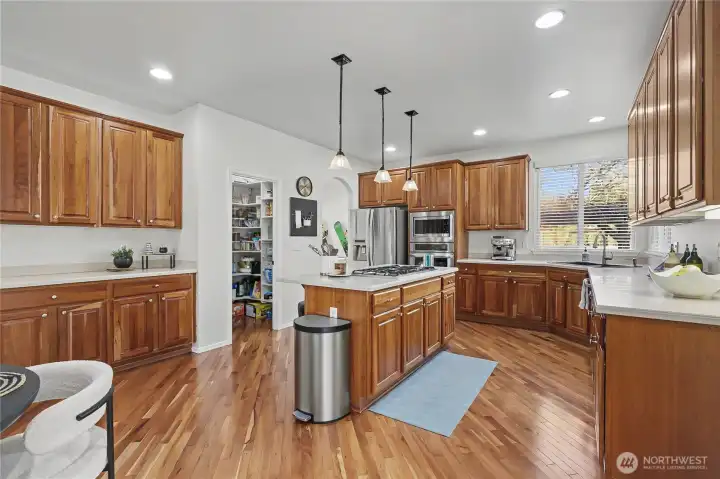 View of kitchen and dine-in area from patio doors. Note the butler's serving area to the left - extra cabinets and counter space! Ideal for entertaining.