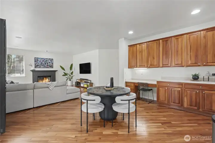 View of your dine-in kitchen area and family room from the kitchen. I love the gas fireplace, one of THREE in this magnificent home. The long buffet area and planning desk is an amazing added benefit.