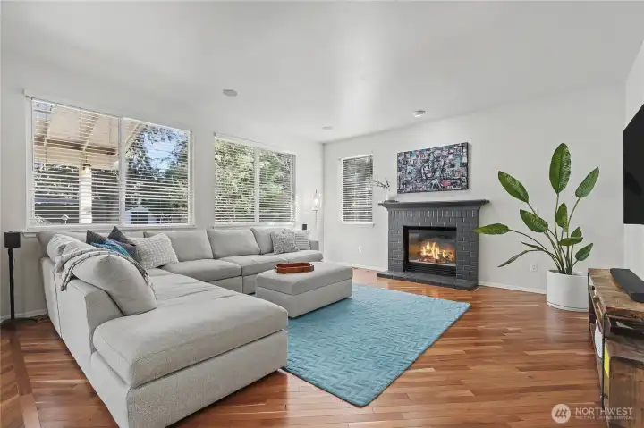 View of your family room, I love all the large windows in this home. Very private backyard and territorial views as you relax by the fire.