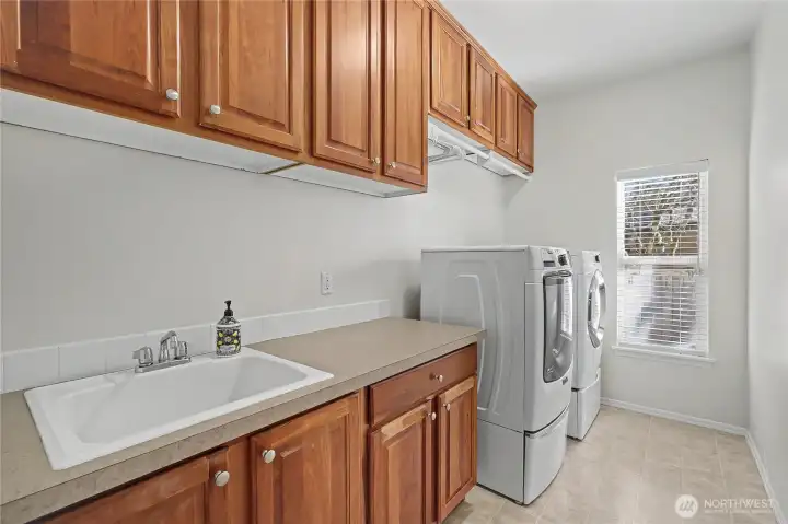 Large utility room with large sink, folding counter and look at all those cabinets!