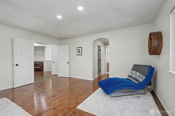 Primary ensuite bedroom view one, I love the double door entry, hallway to your right leads to his & hers closets and your ensuite bath. Tray ceiling and most generous in size.