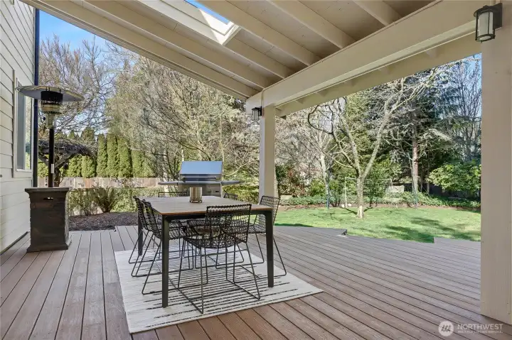 View of your outside covered dining area off of the kitchen, patio heater and BBQ grill stay!