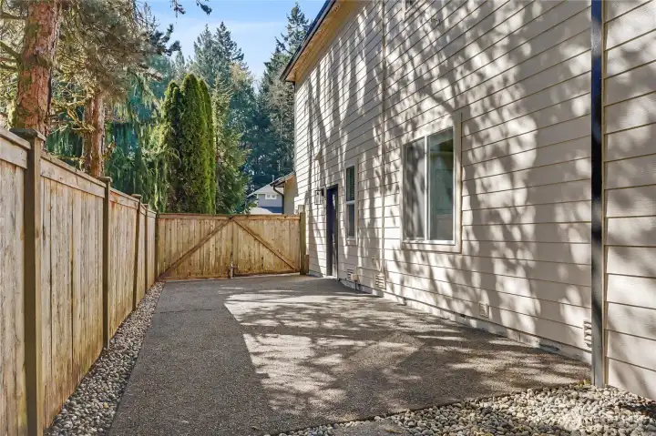 View of the right side of the backyard showing the paved RV/Boat parking area.