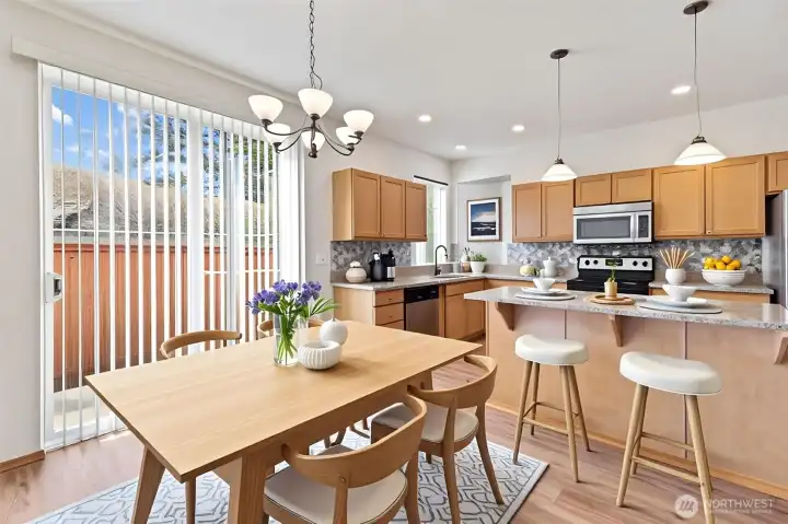 Virtually staged Dining area, kitchen, Center island with bar. Sliders lead to backyard