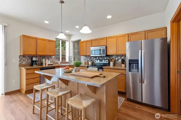 Virtually staged Kitchen. Stainless appliances - Range, microwave and refrigerator stay with house. Walk in pantry on right of picture